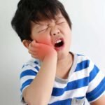 A pediatric dentist in San Diego providing urgent emergency care for a child with a tooth injury.